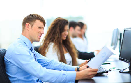 Young employee looking at computer monitor during working day in office