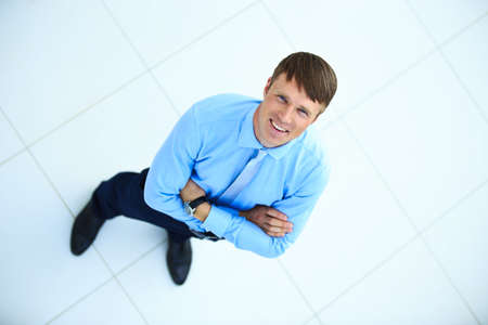 Portrait of a handsome elderly business man standing indoor