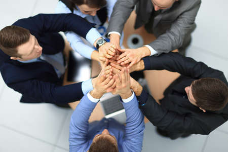 success and winning concept - happy business team giving high five in office. top viewの写真素材