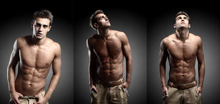 portrait of young strong man against black backgroundの写真素材