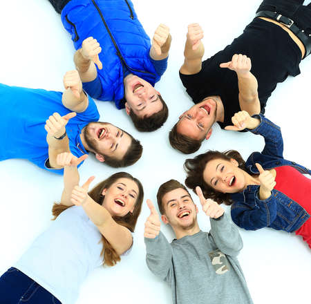 Young people lying down,gesturing thumb up signの写真素材