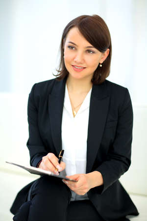 Portrait of happy smiling business woman with black folderの写真素材