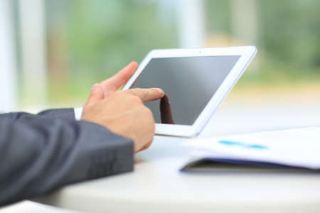 man holding digital tablet, closeup at office