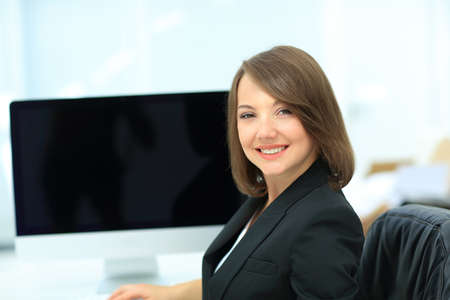 Young pretty business woman with computer in the office