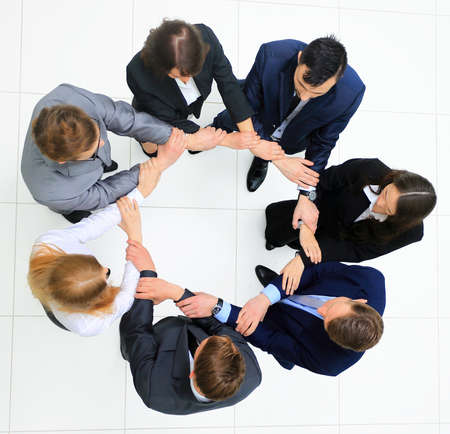 Top view of business people with their hands together in a circle