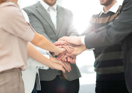 Business team standing hands together in the officeの写真素材