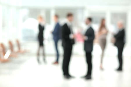 Blurred abstract background of business discussion people group. Blurry view inside office interiorの写真素材