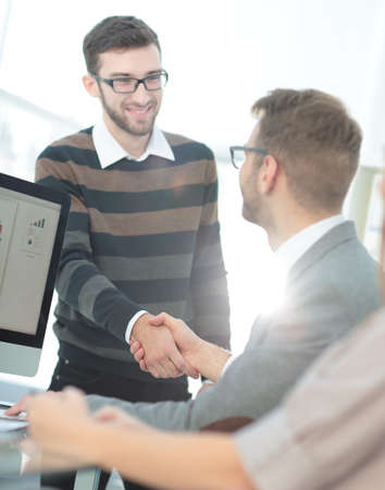 Business people closing a deal and handshaking at the officeの写真素材