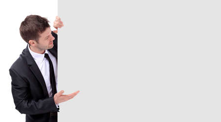 Smiling business man  pointing on product or text.の写真素材