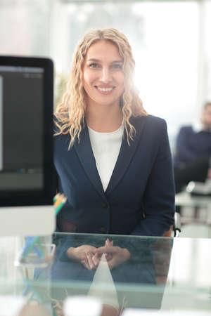 Young business woman standing with her collegues in background at office