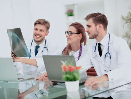 A group of doctors examining an x-ray in the hospitalの写真素材
