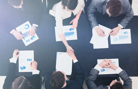 business handshake in office top view