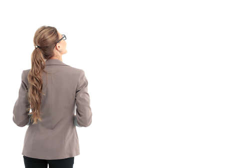 Young businesswoman looking at something. Back view