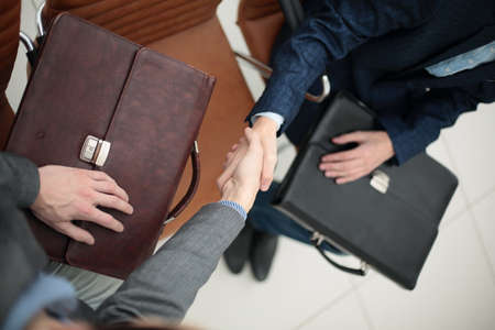 businessman shaking hands to seal a deal with his partnerの写真素材