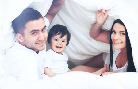 Attractive young family in the bedroomの写真素材