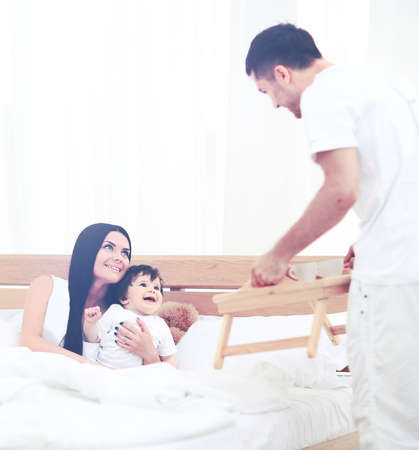 Smiling family having breakfastの写真素材