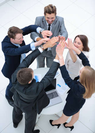 Close up top view of business people putting their hands togetheの写真素材