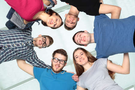 concept of friendship and reliability: a team of students, arms