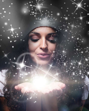 beautiful christmas woman holding magic starsの写真素材