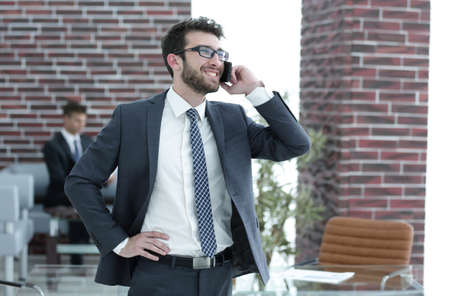 businessman talking on smartphone in his office