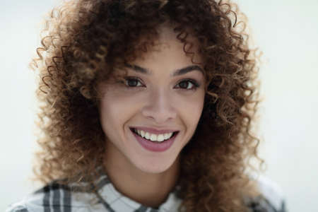 Portrait of a beautiful young woman with curly hair.の写真素材
