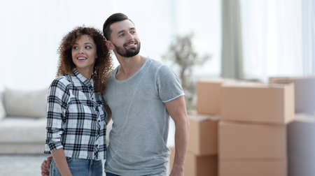 Happy couple standing in new living room
