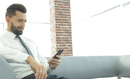 Serious businessman sitting at office desk in office