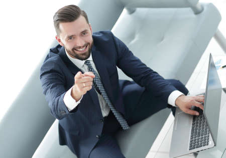 Business concept. Business man with laptop pointing his finger u