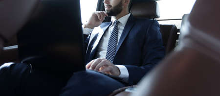 businessman working with laptop and looking out the window of a