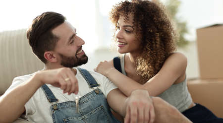 Young couple sitting on couch in new apartment