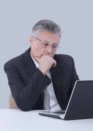 Portrait of a mature gray-haired  business man isolated on whiteの写真素材