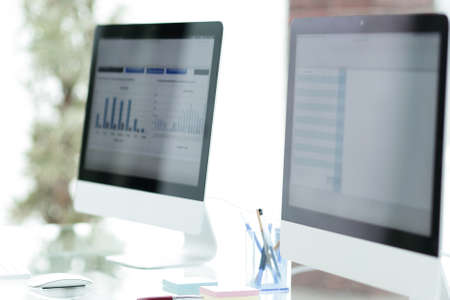 close-up of the screens of personal computers on a modern workplace in the office.の写真素材