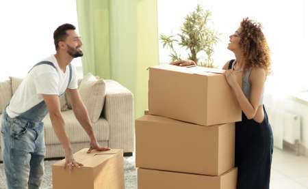 Happy and young couple looking at boxes