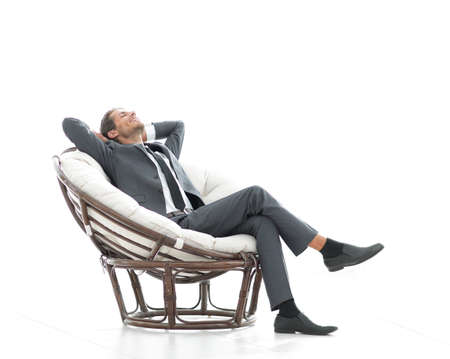happy businessman relaxing in big comfortable armchairの写真素材