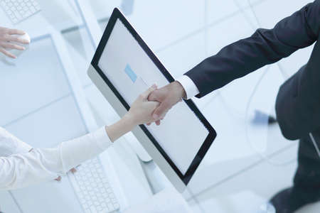 view from the top. Manager shaking hands with the employee over a work Desk.