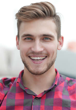 closeup portrait of young man sitting in a chairの写真素材