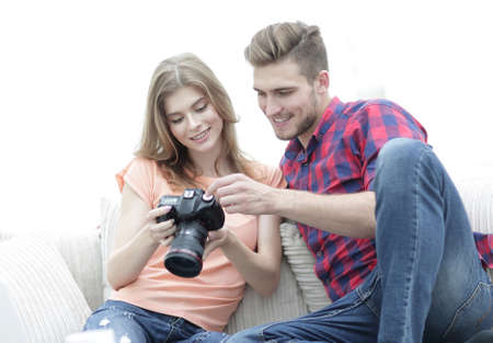 happy young couple checks photos on photos the cameraの写真素材