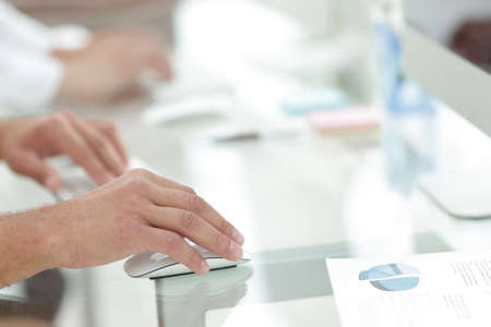 hands typing text on the computer keyboard. blurred business background.の写真素材