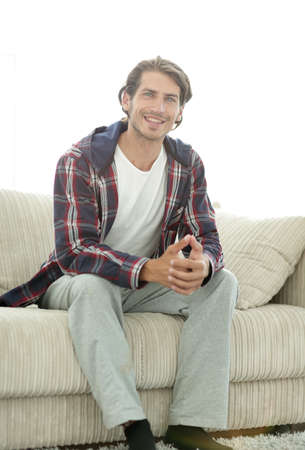 portrait of modern guy sitting on sofa