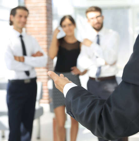 background image of businessman holding out hand for a handshake.の写真素材