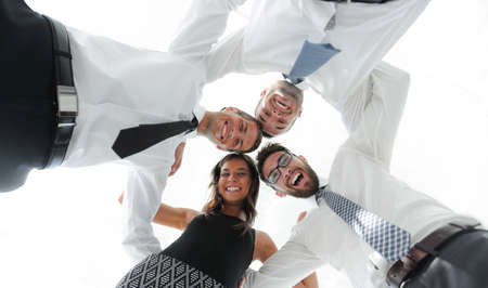 successful business people with arms around each others shoulders.