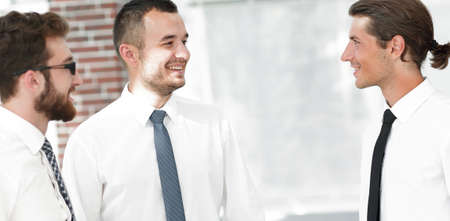 employees are talking ,standing in the office.の写真素材