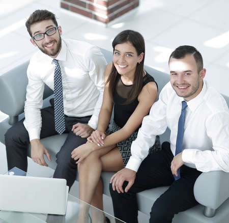 friendly business team sitting in office lobby