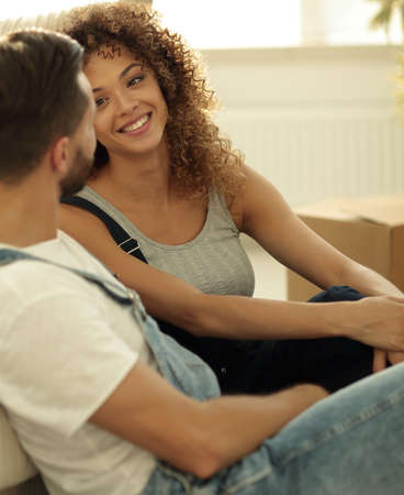Close-up of newlyweds sitting on the couch in a new apartmentの写真素材