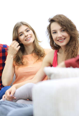group of cheerful friends sitting on sofaの写真素材