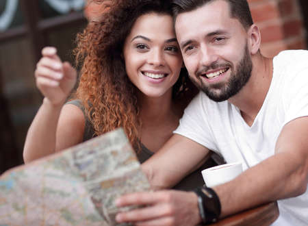 A picture of  tourists looking at map in a cafeの写真素材