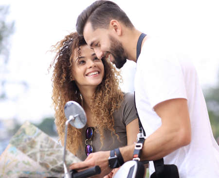Scooter ride. Beautiful couple riding scooter together.の写真素材