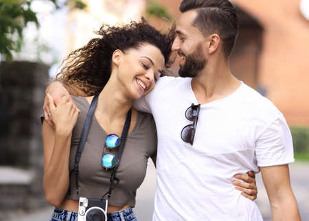 Cheerful young couple walking on urban streetの写真素材