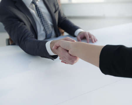 Successful businessmen handshaking after good deal.