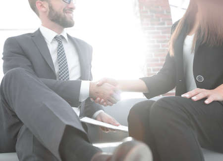 Close-up of two business people shaking handsの写真素材